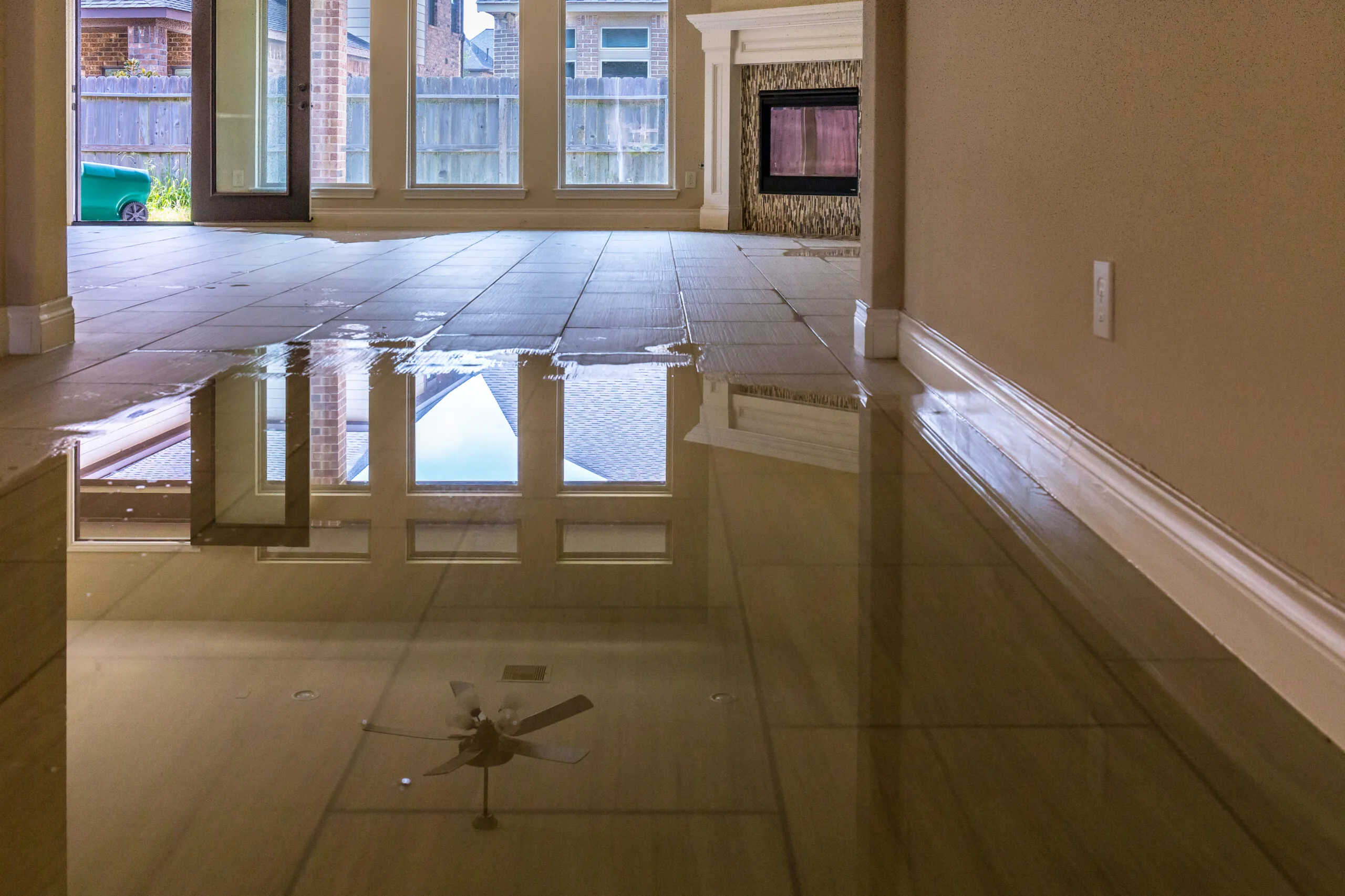 Flooded living room with standing water after water damage